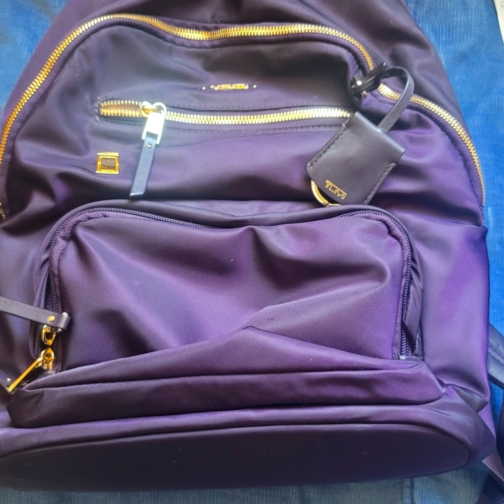 Tumi backpack and wallet - eggplant colored. Almost new.